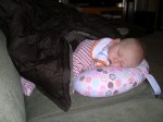 Nicky sleeping in the Boppy while Mommy and Daddy clean up the Christmas stuff