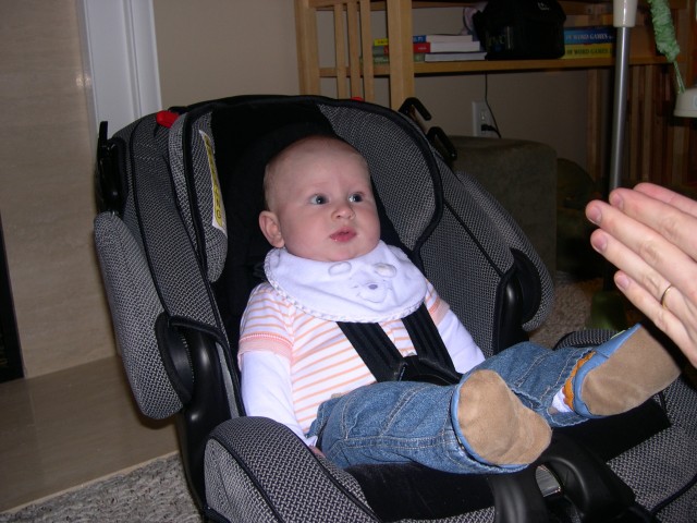 Nicky in his new car seat watching Daddy