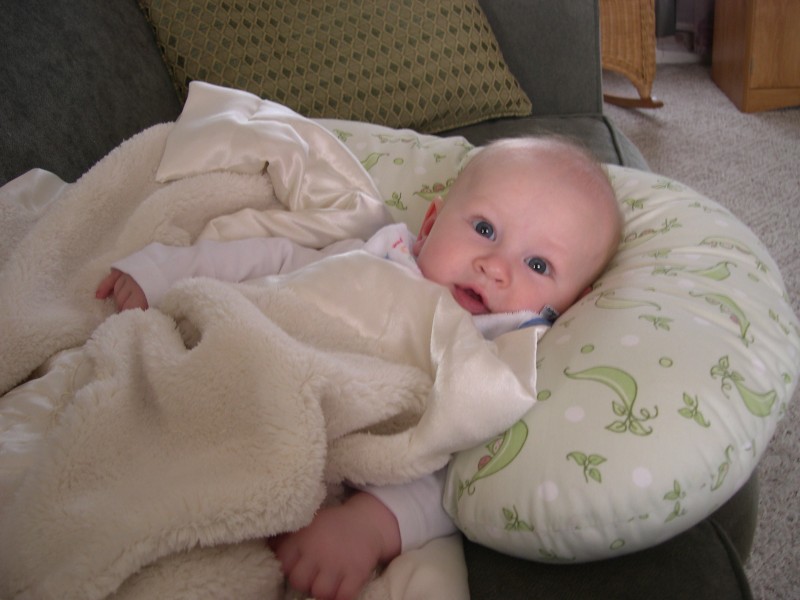 Nicky snuggled in the boppy with the magic blanket