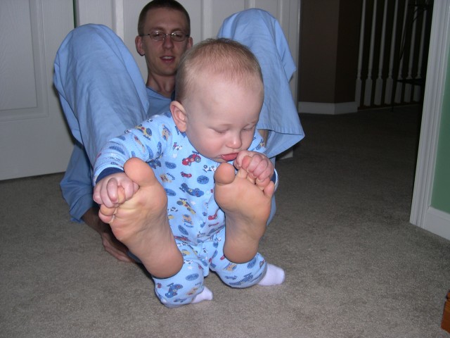 Nicky playing with Daddy's feet