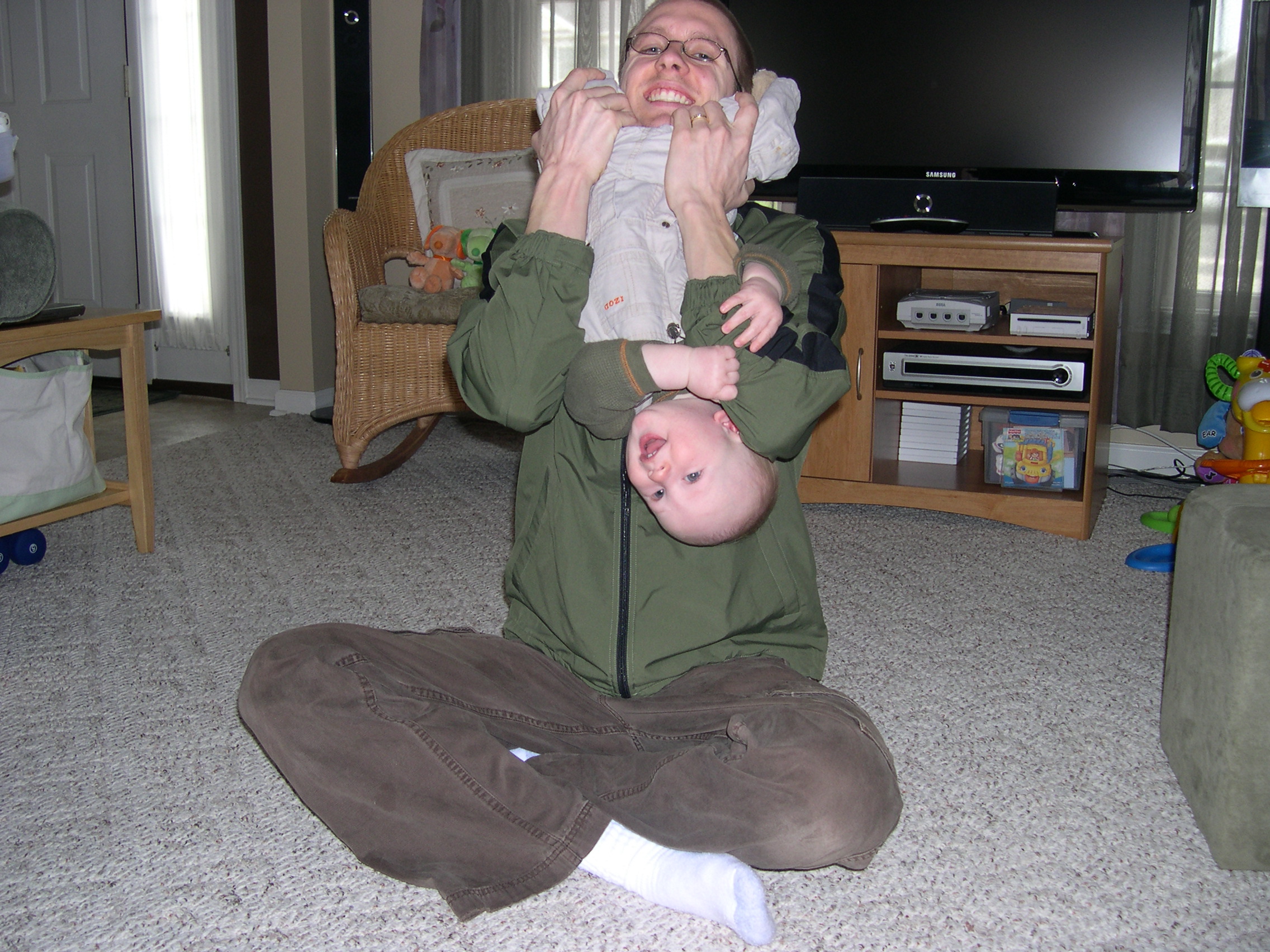 Daddy holding Nicky upside down