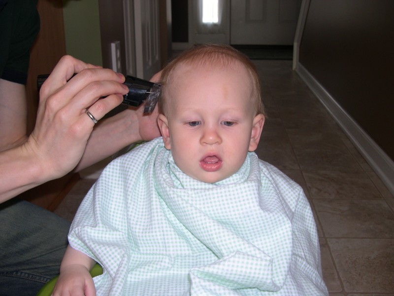 Daddy using the buzz clippers to cut Nicky's hair