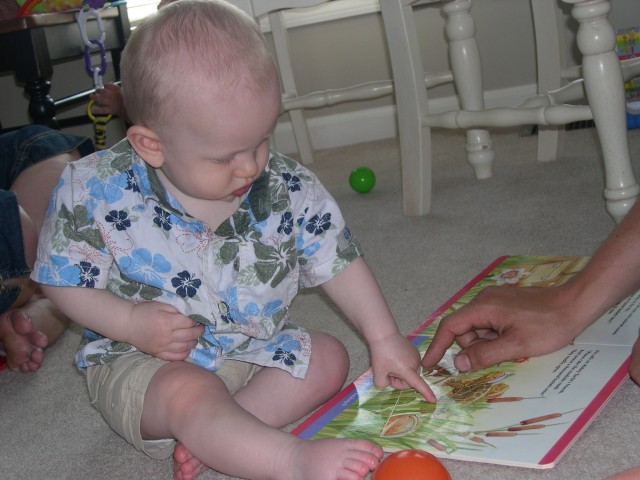 Nicky looking at a book with Craig (Darren's brother)