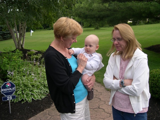 Nicky plays with Aunt Patty's necklace while Grandma Chris watches