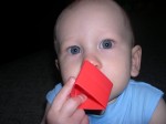 Nicky likes to put his blocks over his nose