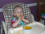 Nicky trying out his feeding trainer with butternut squash and applesauce