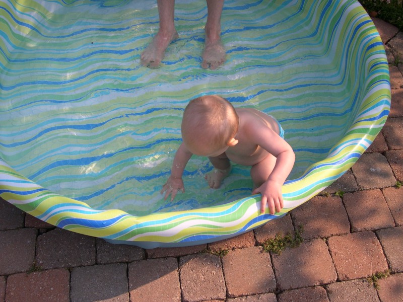 Testing the water with his hands