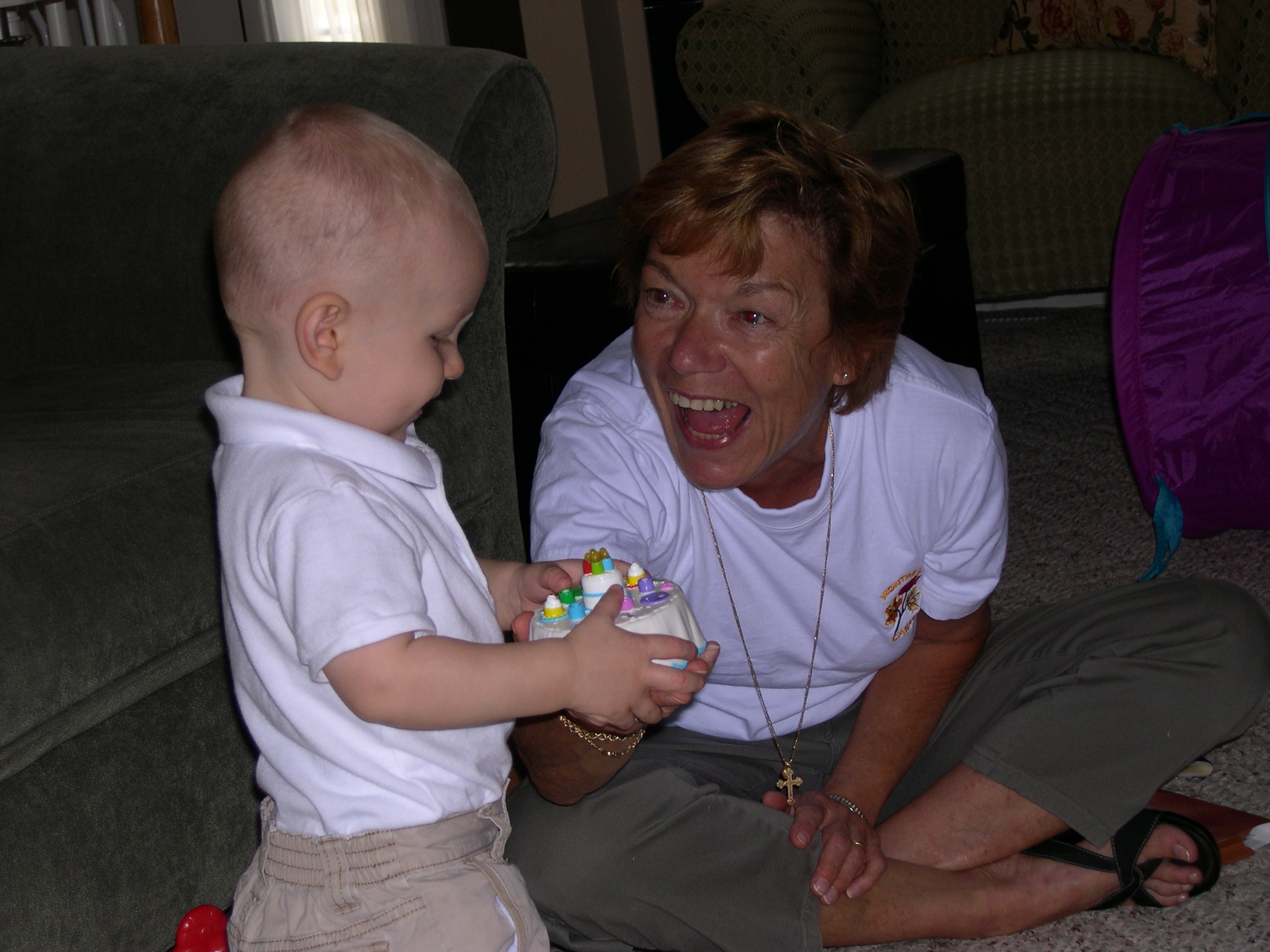 Showing our neighbor, Joan, his musical birthday cake