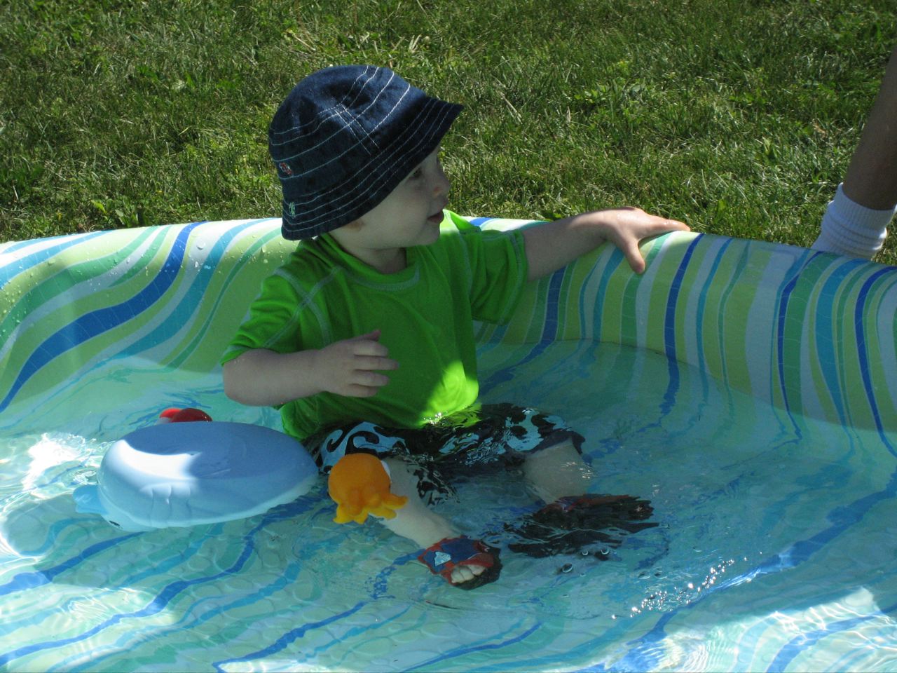 Nicky playing with toys in the pool