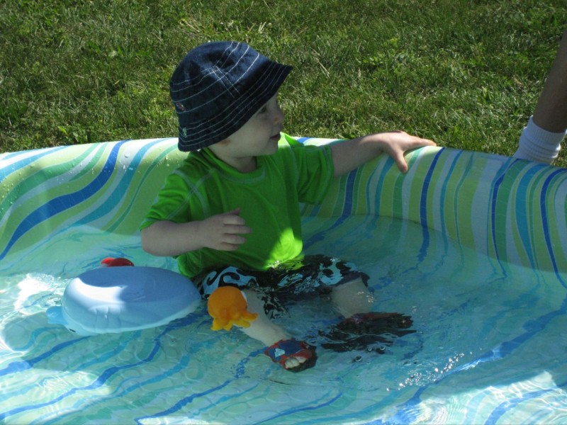 Nicky playing with toys in the pool