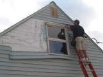 Ron removing the siding to get the old windows out