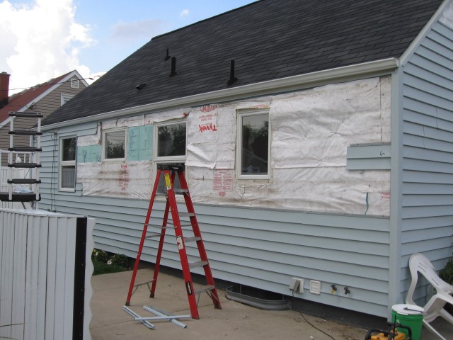 Back of the house with some of the siding removed