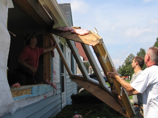 Mike helping carry the old window away