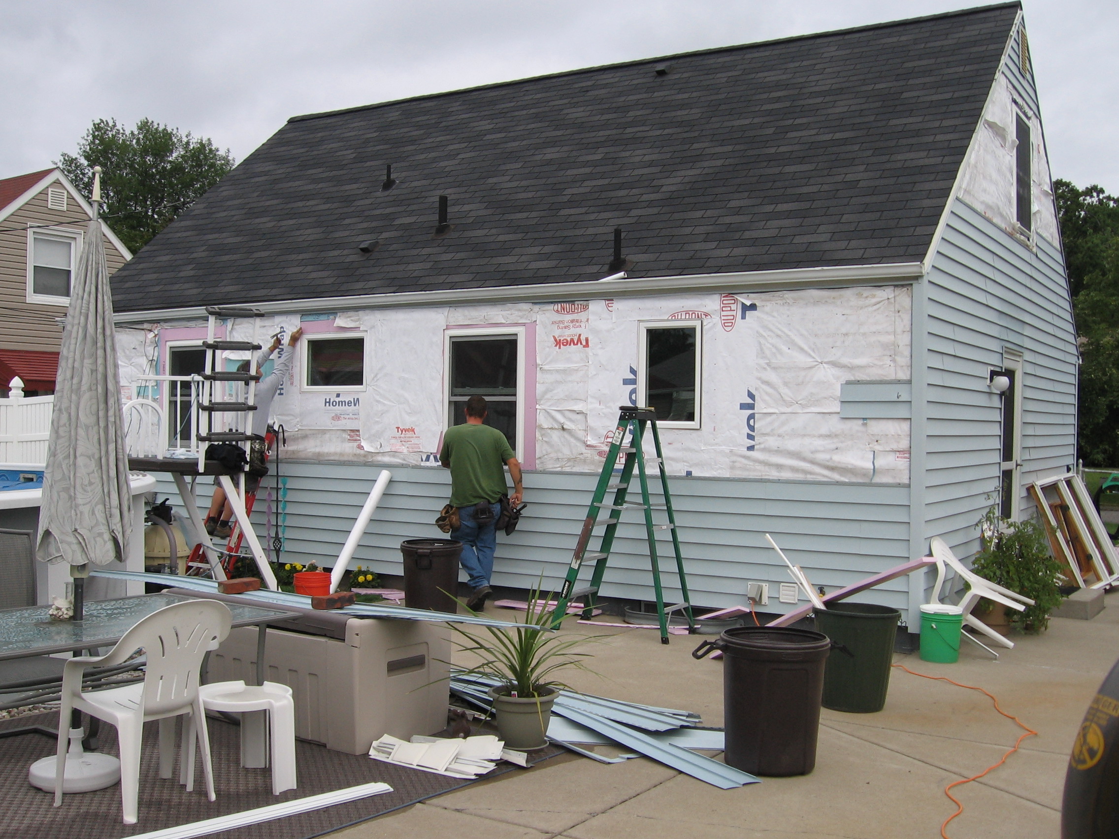 Ed and Bill putting the siding back up on the back of the house