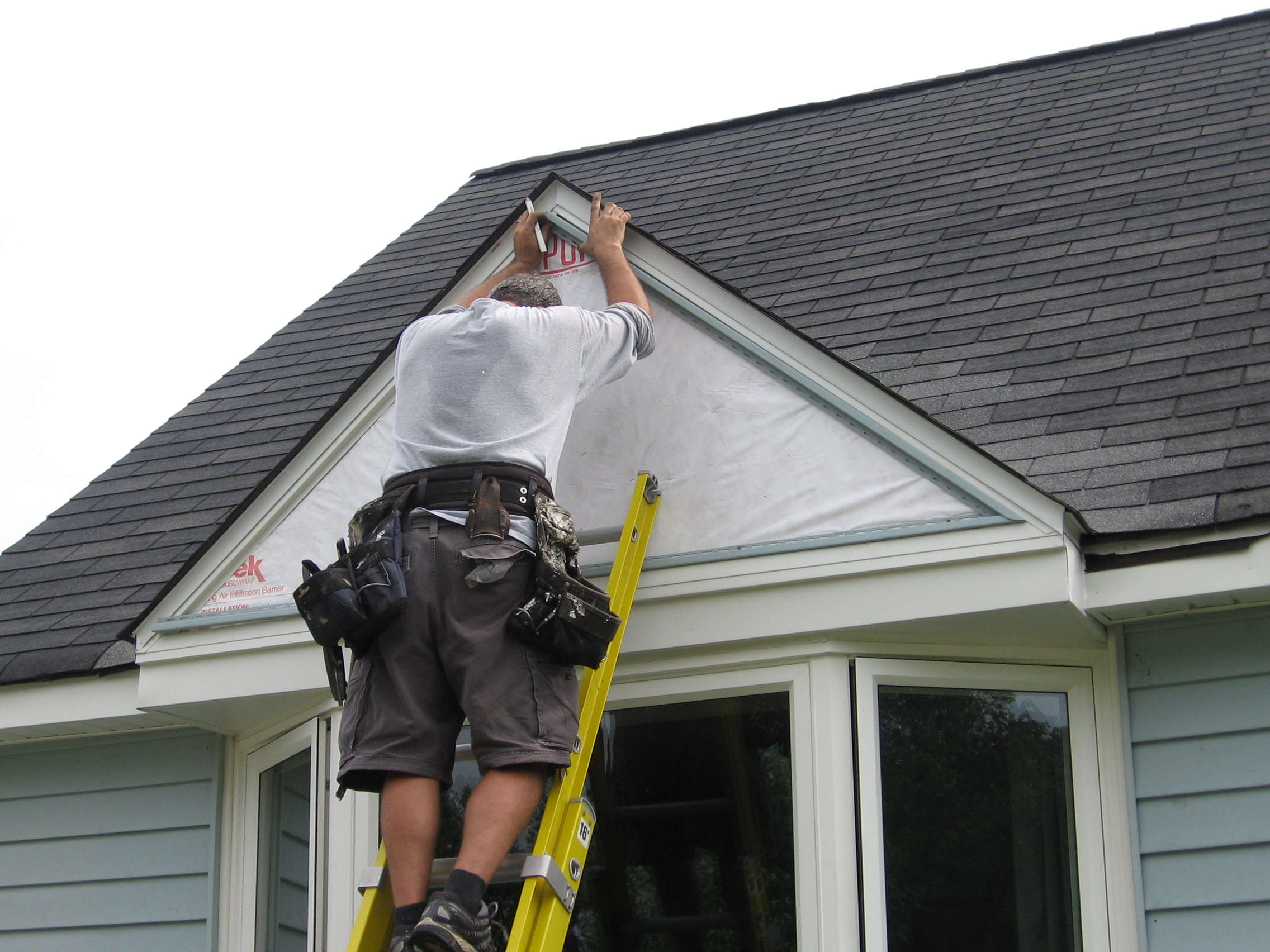 Putting up channeling for siding on peak