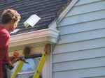 Working on the gutter over the front door.