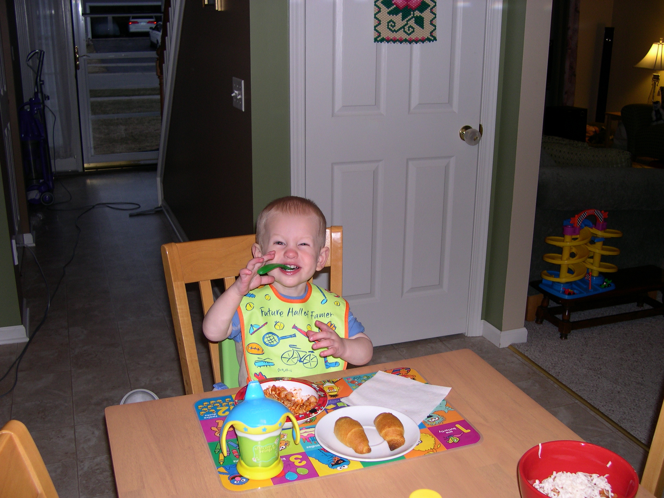 Nicky eating dinner with his booster seat