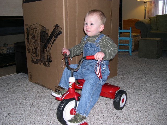 Nick tries out his new tricycle from Grandma Karen