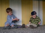 Ben and Nicky playing with stones around Kris and Ang's pool