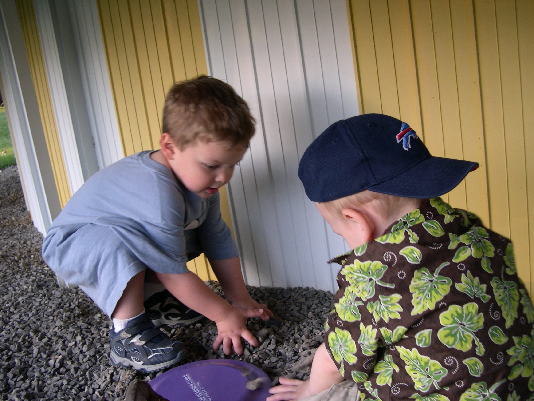 Ben helping Nicky cover the frisbee with stones