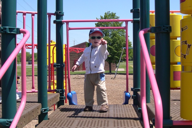 Nicky at the park on the jungle gym