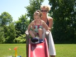 Katie helping Rylie down the water slide