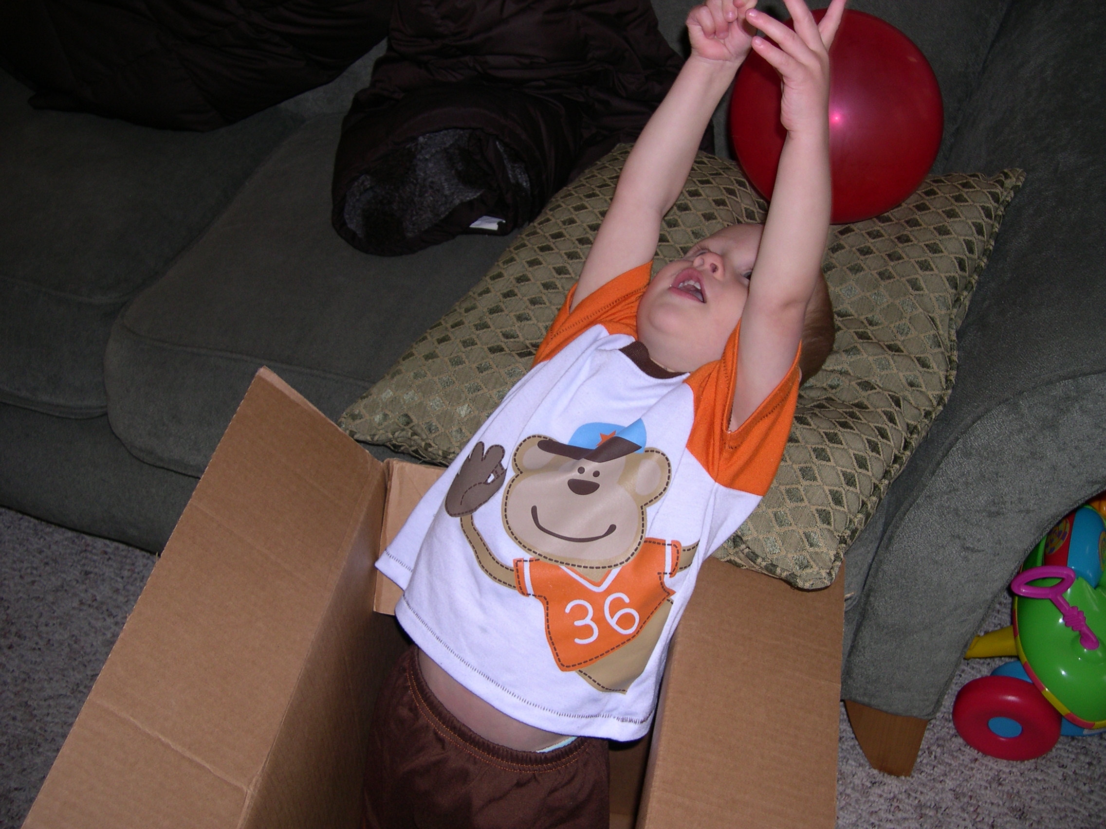 Nicky in a box playing with a balloon