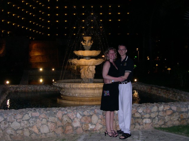 Chuck and Jen pose in front of the fountain