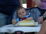 Tyler fully enjoying his first birthday cake.