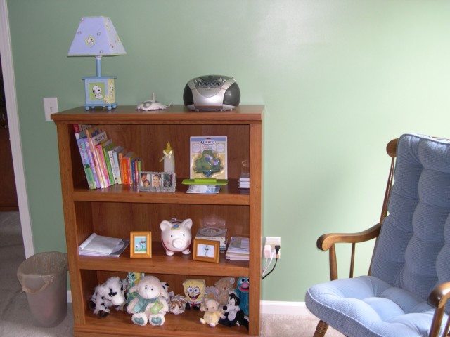 Another view of bookshelf and rocking chair