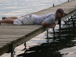 Kevin laying on the dock looking at the ducks