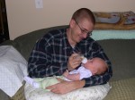 Daddy giving Nicky his first bottle